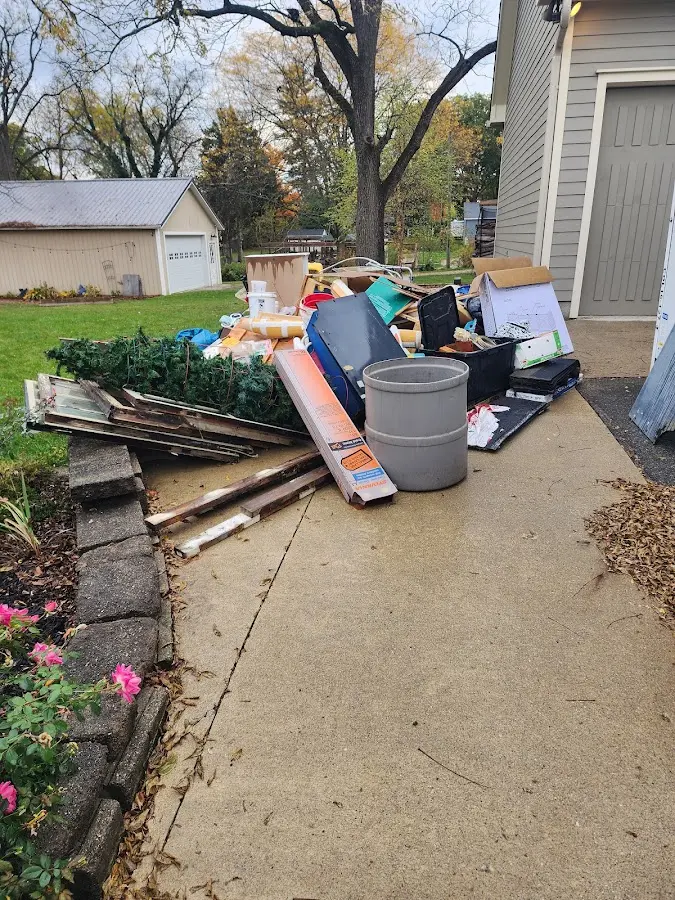 Dumpster being loaded with debris for 12 Yard Dumpster Rental in Reston